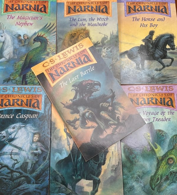 A collection of book covers from 'The Chronicles of Narnia' series by C.S. Lewis, highlighting 'The Last Battle' in the foreground, surrounded by other titles featuring mythical creatures and fantasy elements.