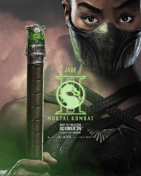 A promotional illustration for 'Mortal Kombat II,' featuring the character Jade, wearing a black mask and holding a staff with a glowing green design. The background includes dramatic colors that enhance the intensity of the scene.