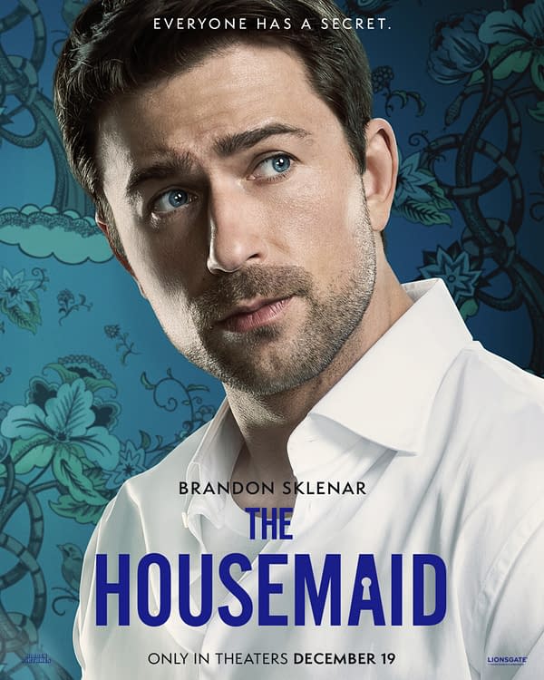 A character poster for 'The Housemaid' featuring a man with dark hair and blue eyes, wearing a white shirt, against a decorative blue floral background. The text displays 'Brandon Sklenar' and the title 'THE HOUSEMAID' prominently.