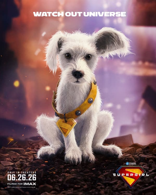 A cartoon illustration of Krypto, a small, white, fluffy dog wearing a yellow collar with a Superman symbol, sitting among rocky terrain, with the text 'WATCH OUT UNIVERSE' above. The image promotes the upcoming 'Supergirl' film, set to release in theaters on June 26, 2026.