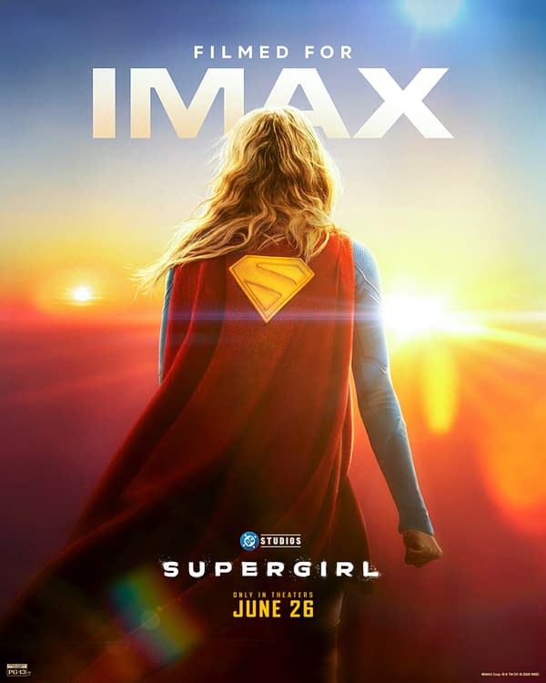 Supergirl stands with her back to the viewer in a bright red cape against a glowing sunrise, with