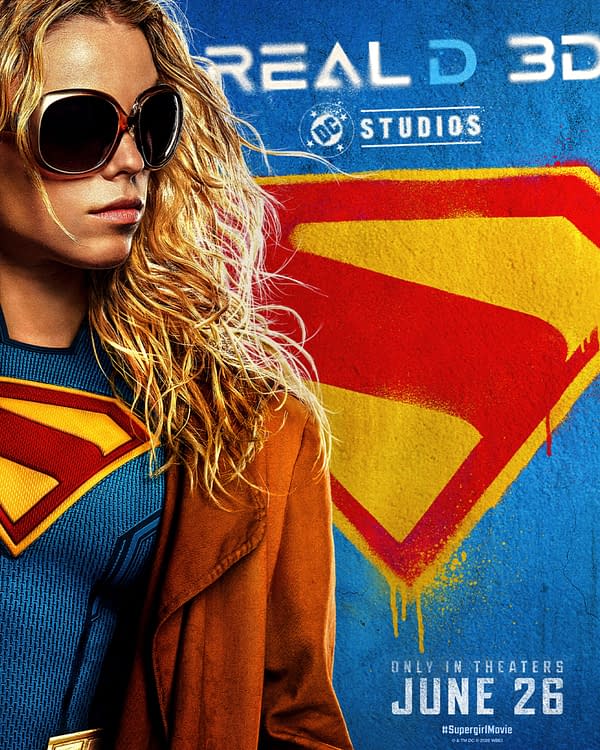 Supergirl movie poster showing Supergirl in sunglasses and a red cape, with the Superman-style emblem behind her and a June 26 release date.