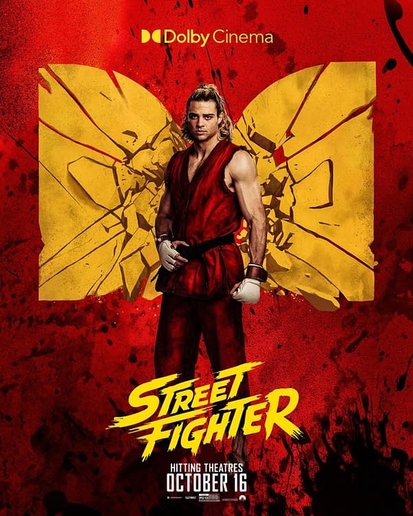 Street Fighter movie poster featuring a martial artist in a red gi and white gloves standing before a shattered yellow emblem on a red background.