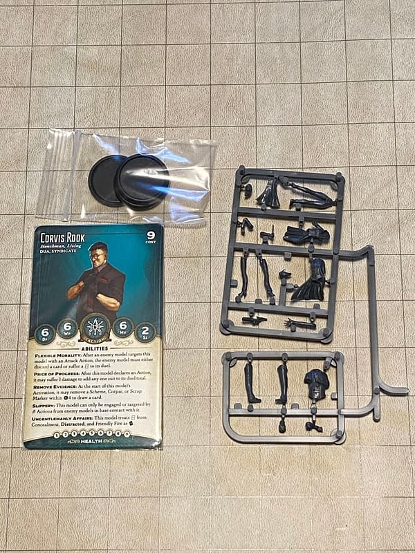 An array of the components you'd see in the Dirty Work boxed set for Wyrd Miniatures' game Malifaux.