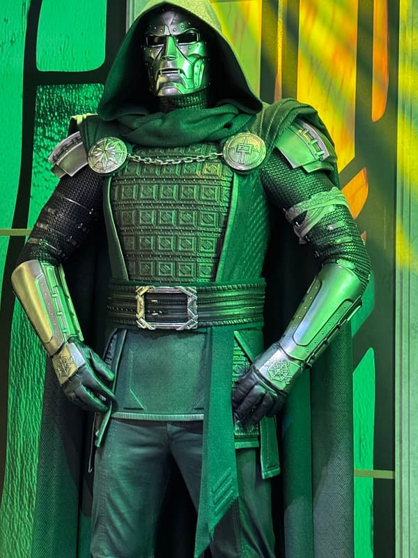 Doctor Doom cosplay costume on display at SDCC, featuring a green hood, metal mask, and armored suit.