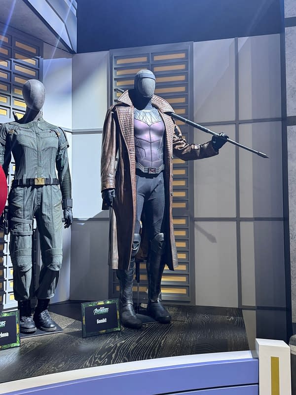 Marvel movie costumes on display at SDCC, including Gambit holding a staff and a Sentinel-style figure beside him.