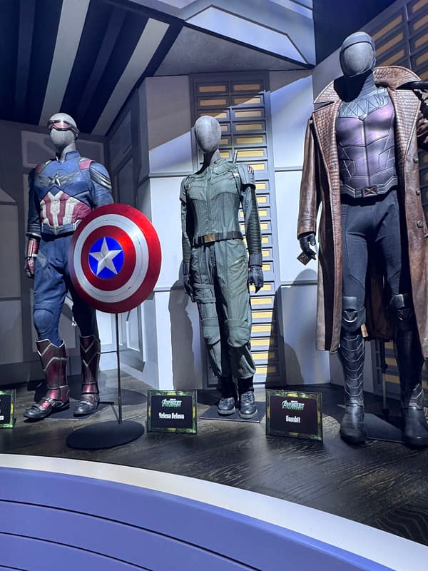 Avengers: Doomsday costume display at SDCC featuring Captain America with his shield, Yelena Belova, and Gambit mannequin suits.