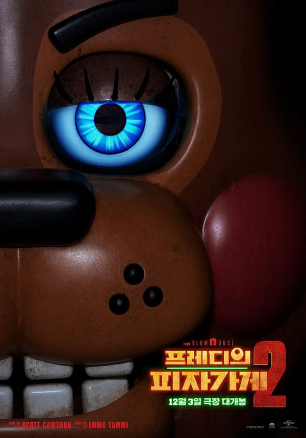 A close-up of a cartoon-style animatronic character from 'Five Nights at Freddy's 2', featuring an eerie expression with a prominent blue eye. The image includes a logo with text in Korean and an announcement for a release date.