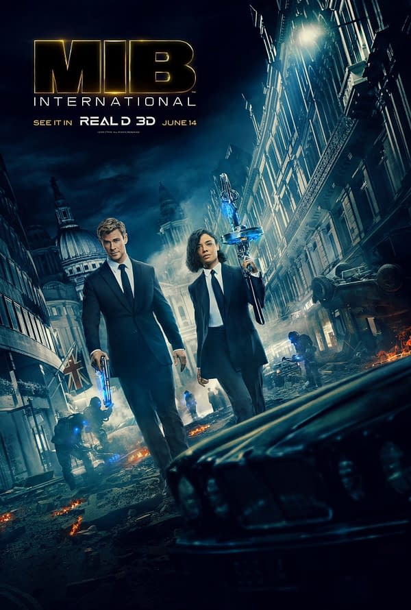 Promotional poster for 'Men in Black: International' featuring two suited agents, one male and one female, holding futuristic weapons against a backdrop of a damaged city with smoke and debris.