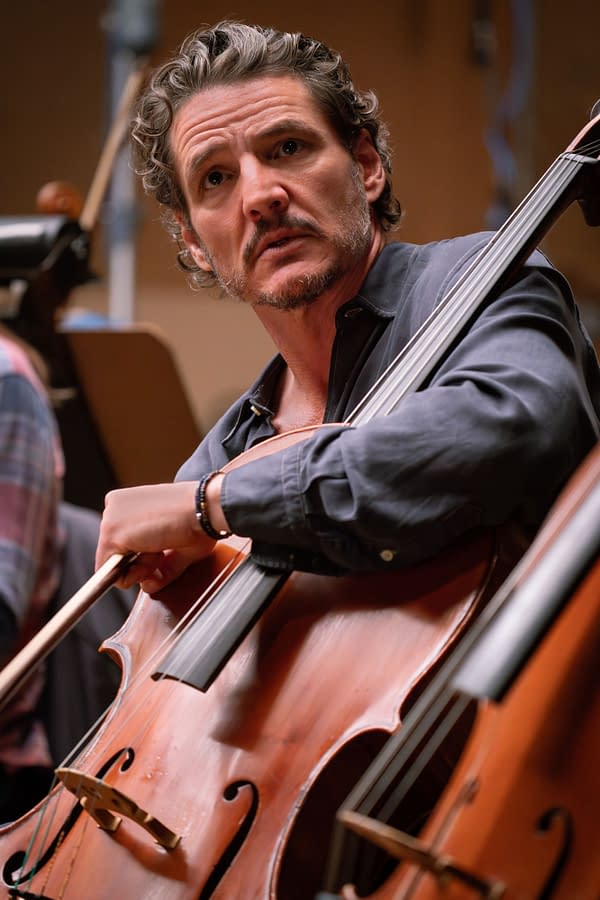 Pedro Pascal plays a cello in BEHEMOTH!, looking intently off to the side during a recording session.