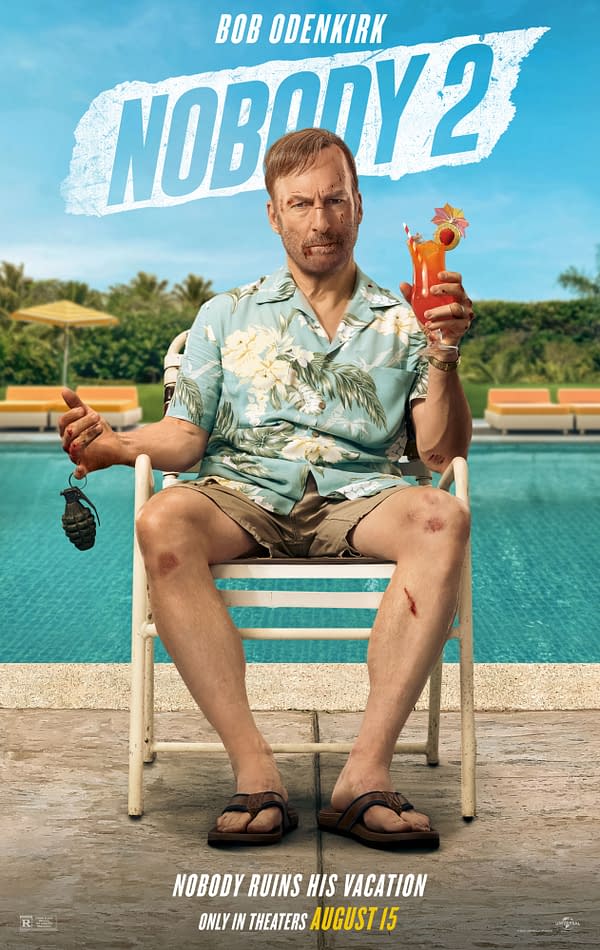 This promotional image for 'Nobody 2' features Bob Odenkirk sitting by a pool, holding a tropical drink in one hand and a grenade in the other. He is wearing a floral shirt and shorts, with visible cuts and bruises on his legs, emphasizing a humorous take on vacation disaster.