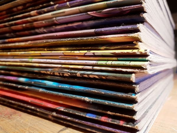 A stack of comic books from comics publishers.