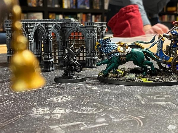 A shot of the Lone King staring up a Stormstrike Chariot's fearsome gryphon mount. What happens next? Read on! Photo credit: Josh Nelson, in a campaign game within the Path to Glory campaign format for Age of Sigmar, a fantasy wargame by Games Workshop.